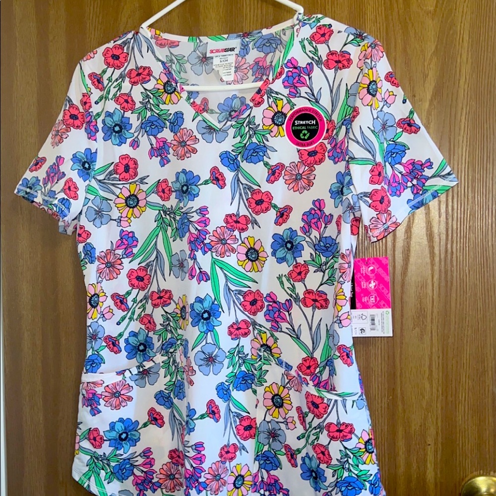 Bundle of scrubs-- all brand new with tags sizes XS and small